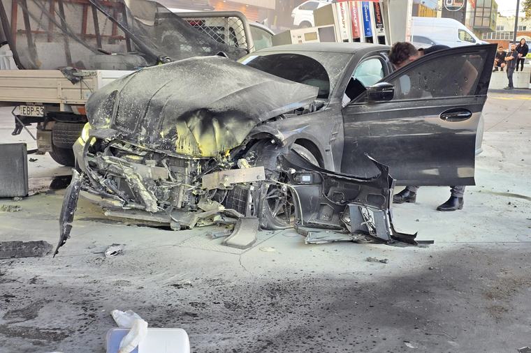 Pedestrian lucky to be alive after BMW M3 goes sideways into a petrol bowser
