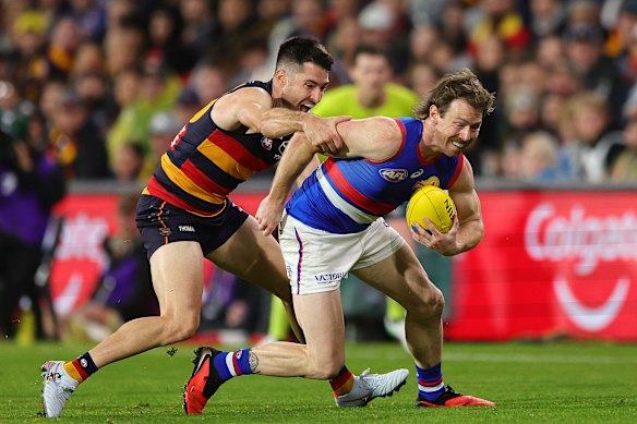 Crows fans stand for their coach as the Bulldogs’ season ends in an elimination final