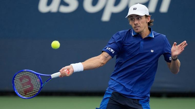 ‘Name of the game’: De Minaur adapts to New York deluge with fast win